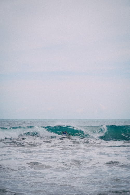 A Person Surfing on Ocean Waves