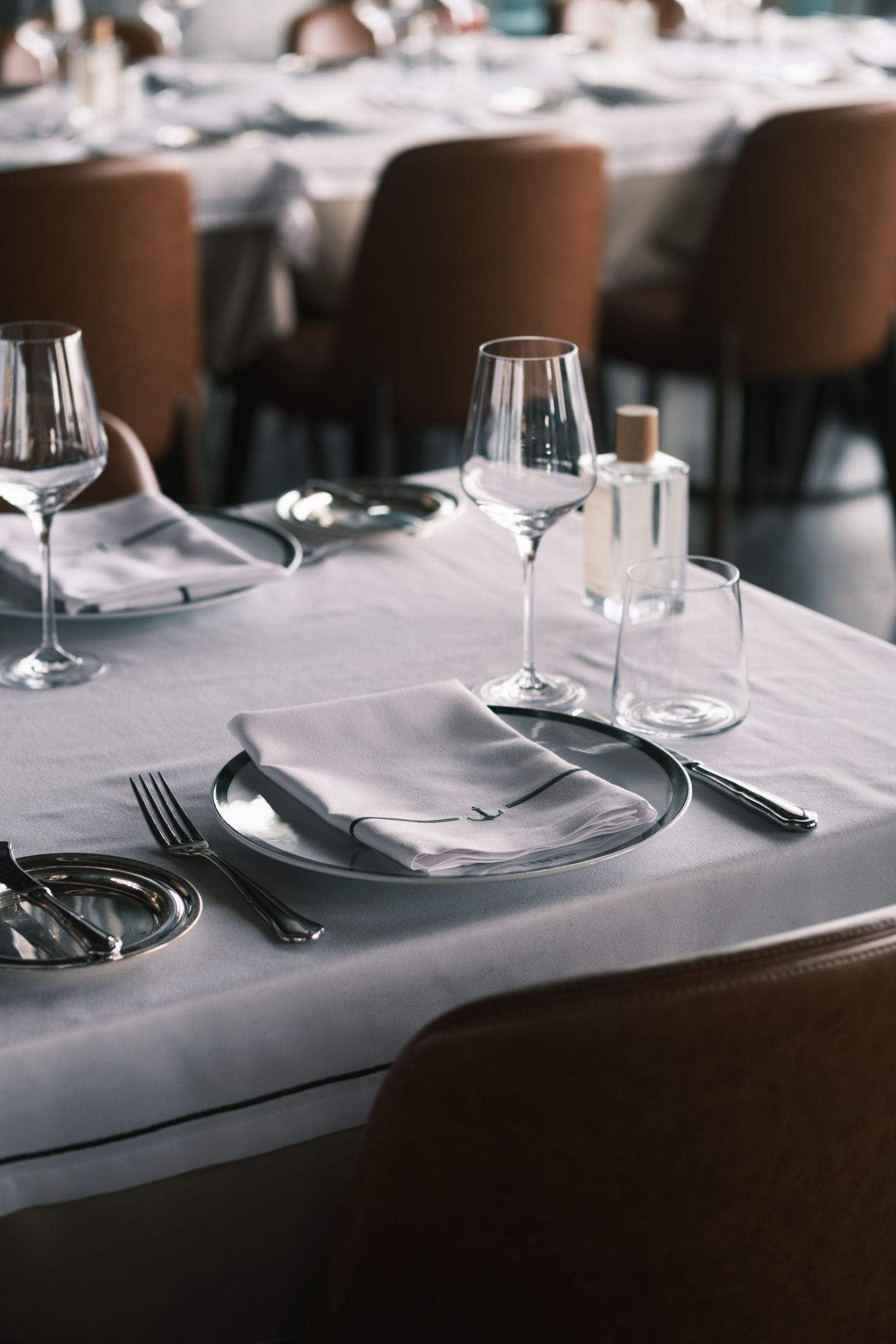 A table laid for dinner with glassware and napkins
