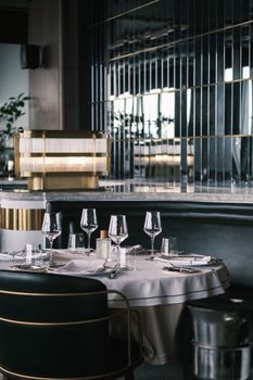 Chic table setup in a modern restaurant with elegant glassware and décor.