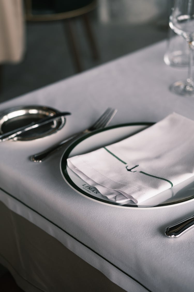 Table Setting Of Branded Plate Cutlery and Serviette 