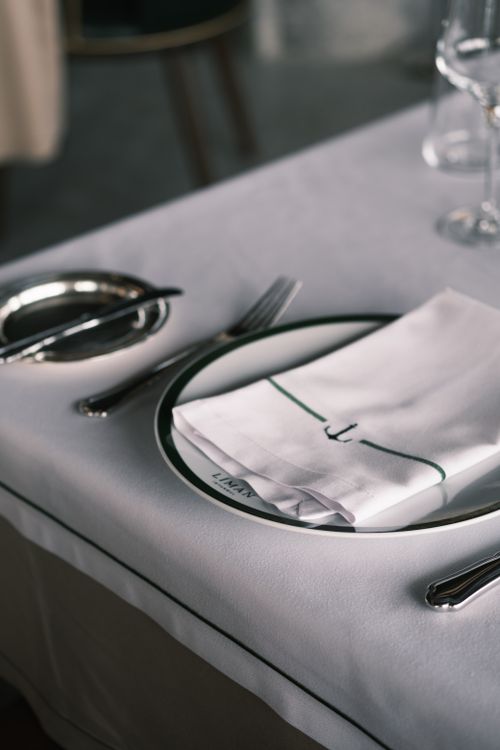Free Close-up of a sophisticated restaurant table setup with cutlery and napkin. Stock Photo
