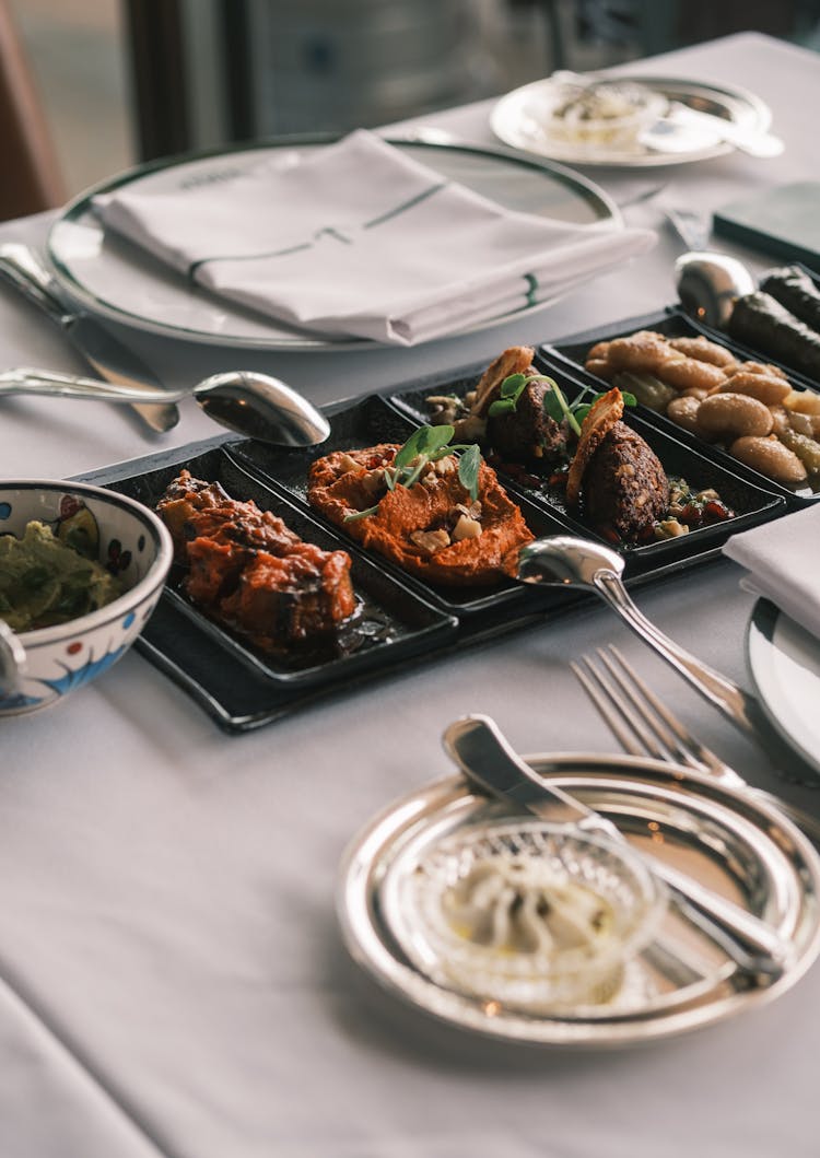 Meat And Vegetable Appetizers Served On Restaurant Table