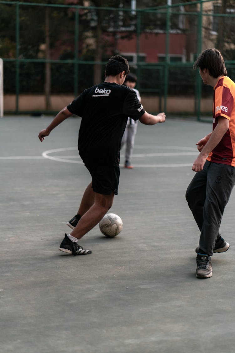 Kids Playing Soccer In A Park