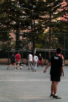 Group of teenagers playing soccer on an outdoor court in Istanbul, Turkey.