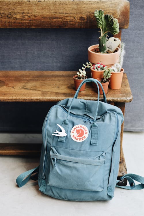 Blue Backpack Beside the Wooden Bench