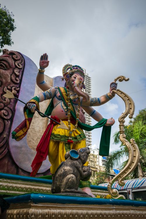 Free Majestic Ganesha sculpture outdoors in Mumbai surrounded by cityscape and greenery. Stock Photo