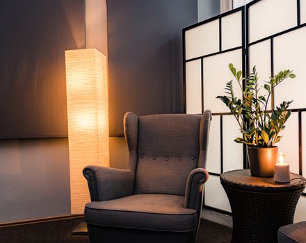 Inviting armchair with glowing floor lamp in a stylish interior setting in Budapest.