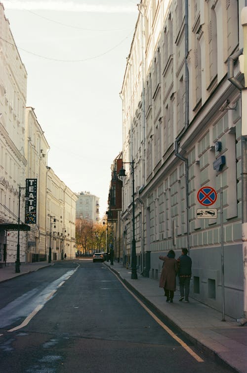 A Couple Walking on the Sidewalk