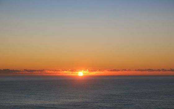A breathtaking view of the ocean under a vibrant sunrise, perfect for serene moments.