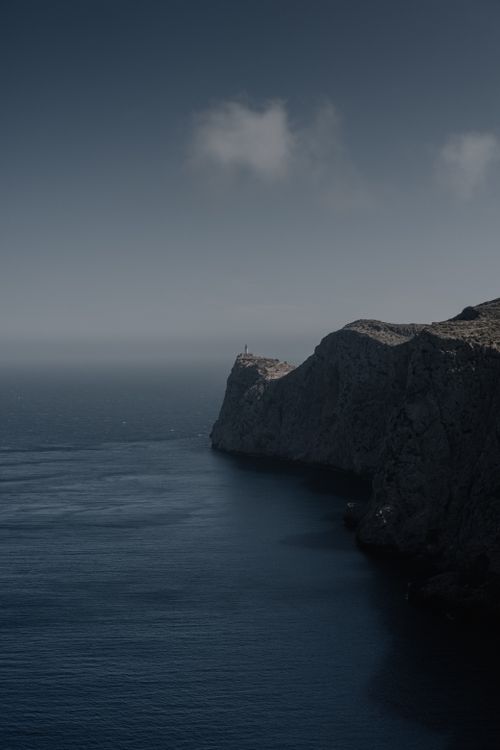 Free A stunning view of a coastal cliff in Ibiza, Spain, captured during the day with a dramatic and moody feel. Stock Photo
