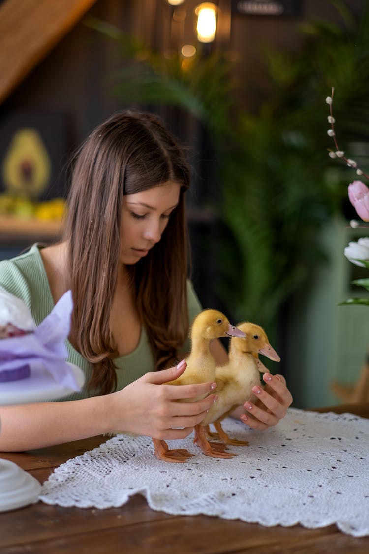 A Woman Holding Ducklings