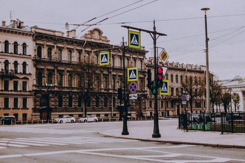 Free A serene city scene featuring classic European architecture and numerous street signs at a quiet intersection. Stock Photo