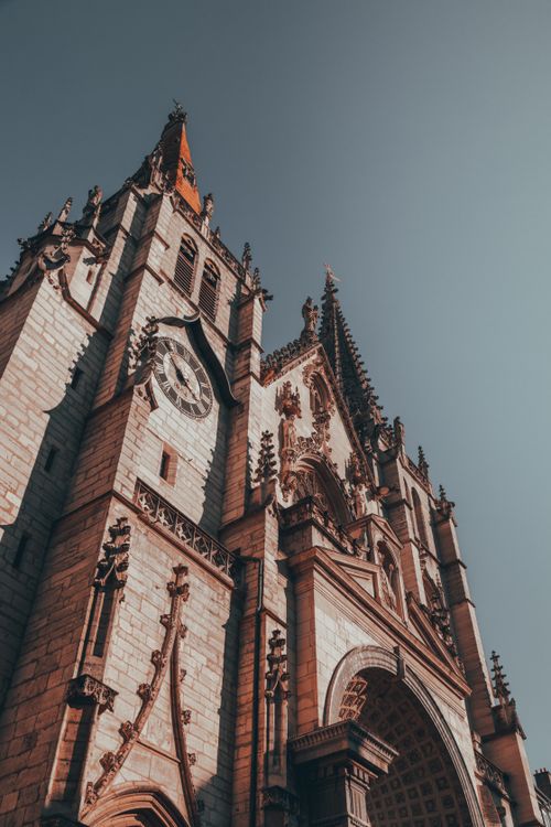 Free Explore the intricate Gothic architecture of Saint-Nizier Church in Lyon, France, under a bright sky. Stock Photo