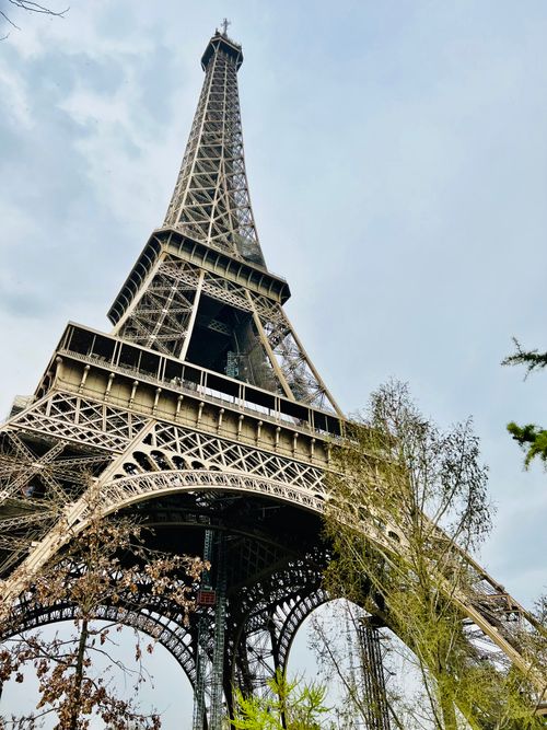 Free Stunning low-angle shot of the Eiffel Tower in Paris, showcasing its architectural beauty. Stock Photo