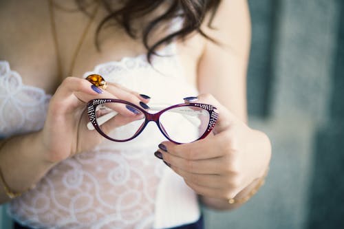 Closeup Photo of Person Holding Eyeglasses