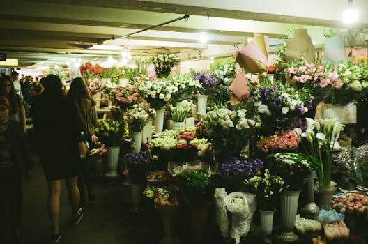Colorful floral arrangements on display at a bustling underground flower market in Kyiv, Ukraine.
