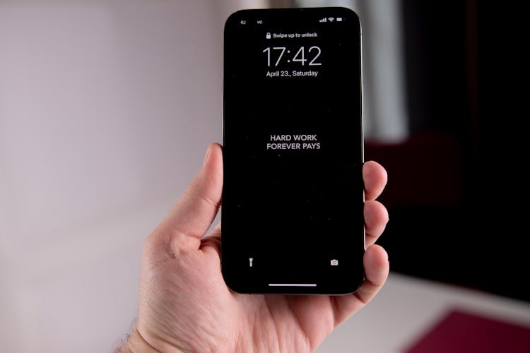 Photo Of A Person's Hand Holding A Phone With An Inspirational Message