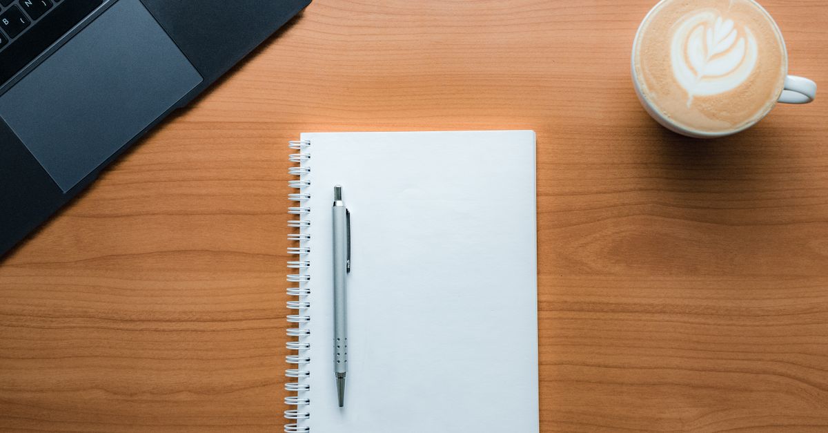 minimalist desk workspace with notebook and coffee