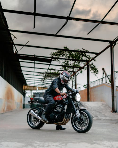 Man in Black Jacket Riding Black Motorcycle