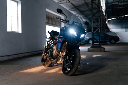 Free Black Motorcycle Parked on Gray Concrete Road Stock Photo