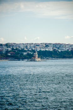 A scenic view of the iconic Maiden's Tower located in the Bosphorus Strait, Istanbul, surrounded by the sea.