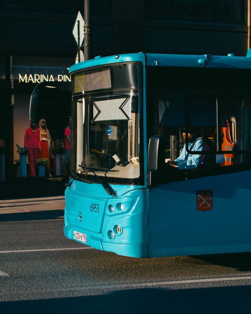 Free A vibrant blue public bus navigating Saint Petersburg's urban streets, cityscape view. Stock Photo