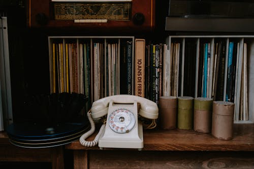 Free White Rotary Phone on Brown Wooden Shelf Stock Photo