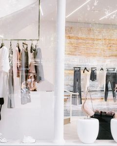 Chic fashion display at a clothing store with stylish reflections.