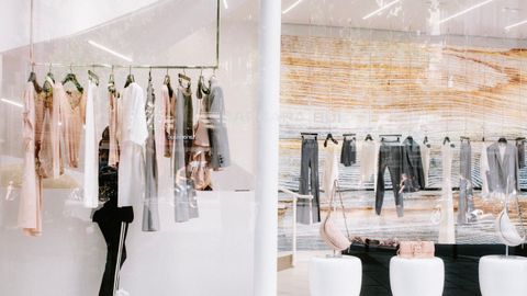 Chic fashion display at a clothing store with stylish reflections.