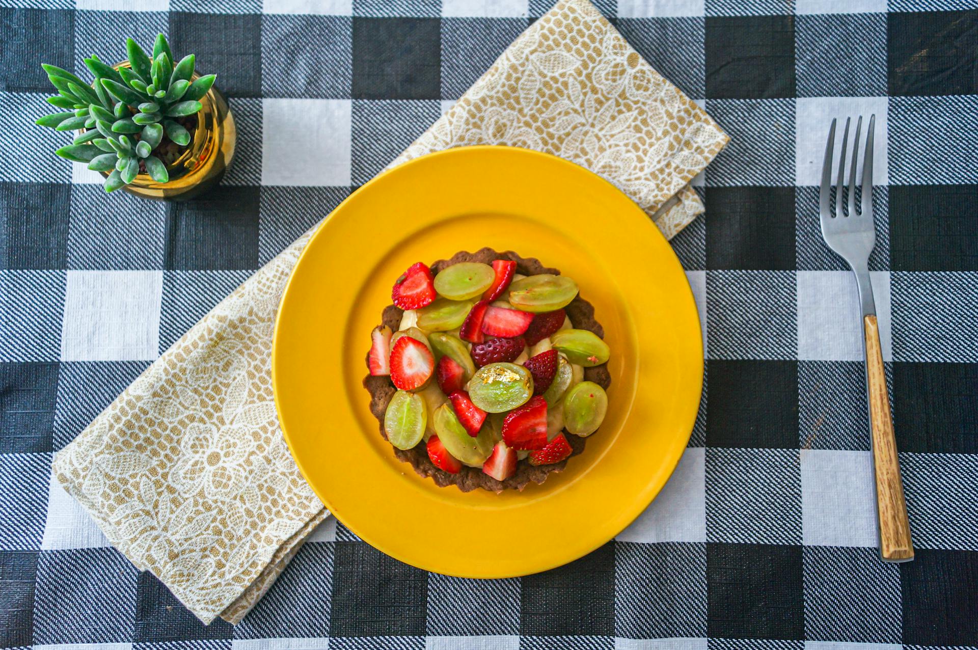 Sliced Strawberries and Green Grapes on Pie Crust