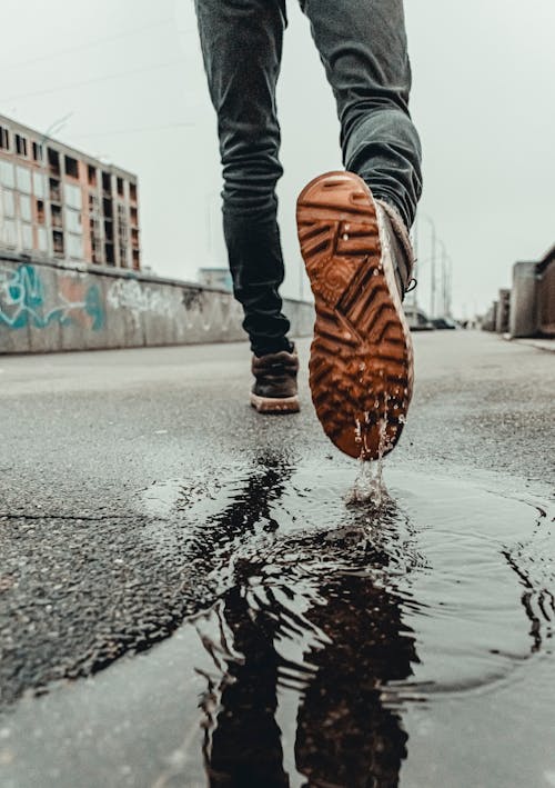 Free Person Stepping on a Puddle Stock Photo
