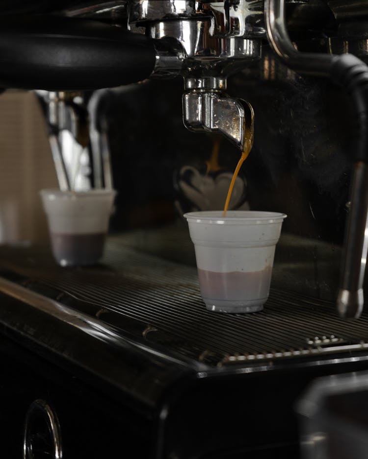 Photo Of A Coffee Machine With Plastic Cups