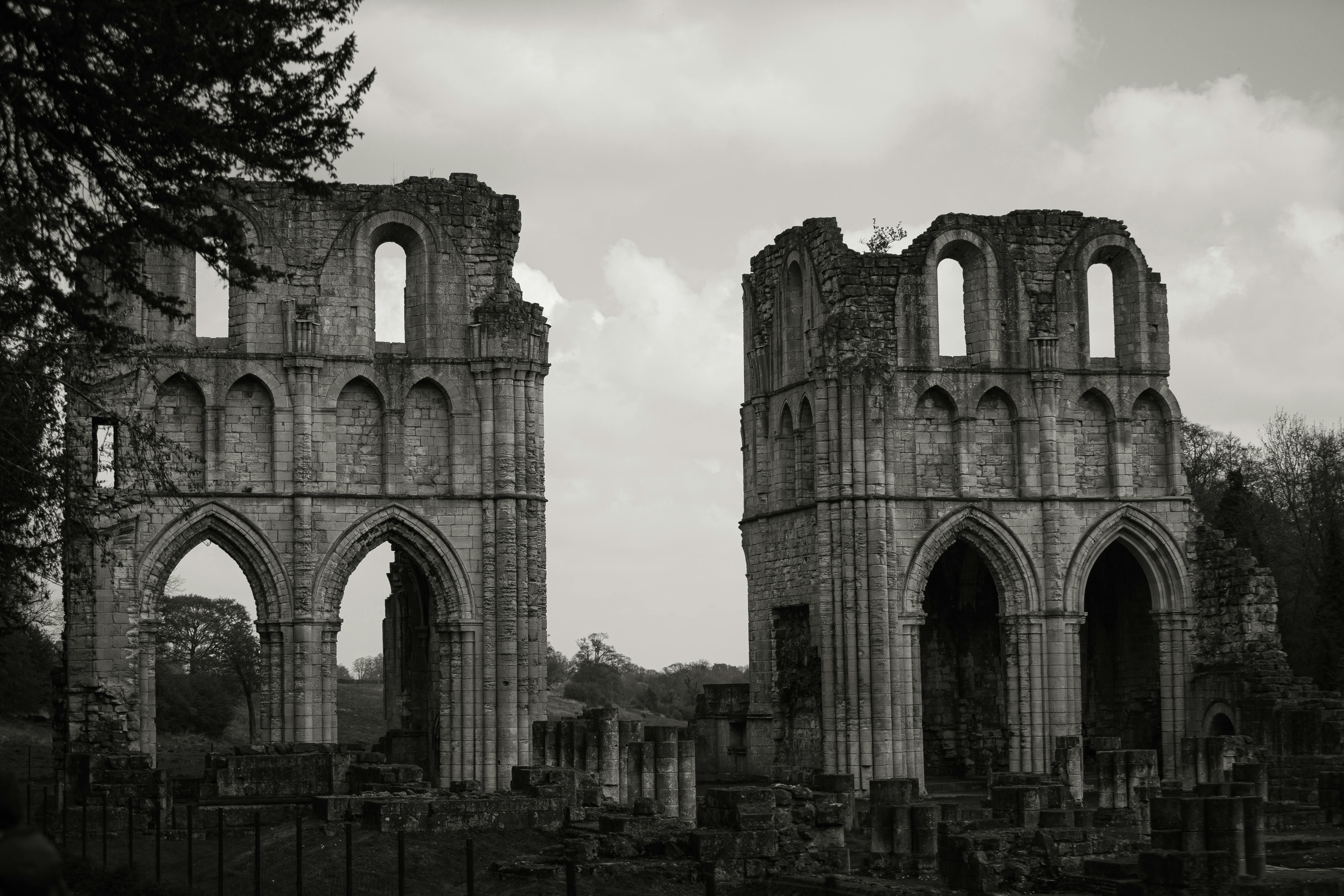 Capture of Roche Abbey's gothic ruins in black and white, highlighting its historic grandeur.
