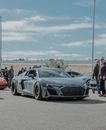 People Standing Beside Red and Black Sports Car