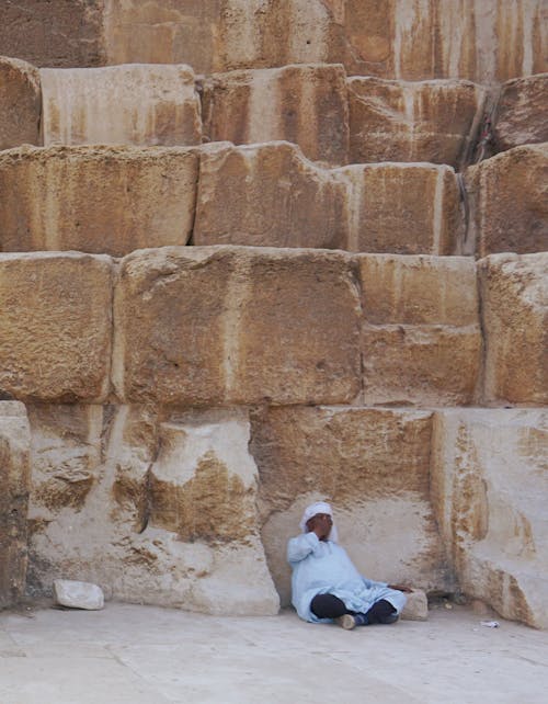 Man relaxing near pyramid