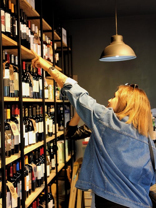 Free A Woman Choosing Wine Stock Photo