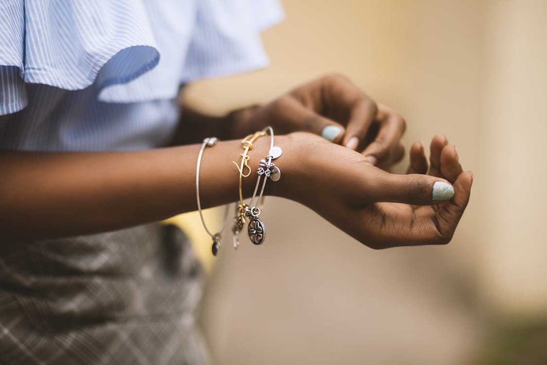 Free Selective Focus Photography of Person Wearing Three Bangles Stock Photo