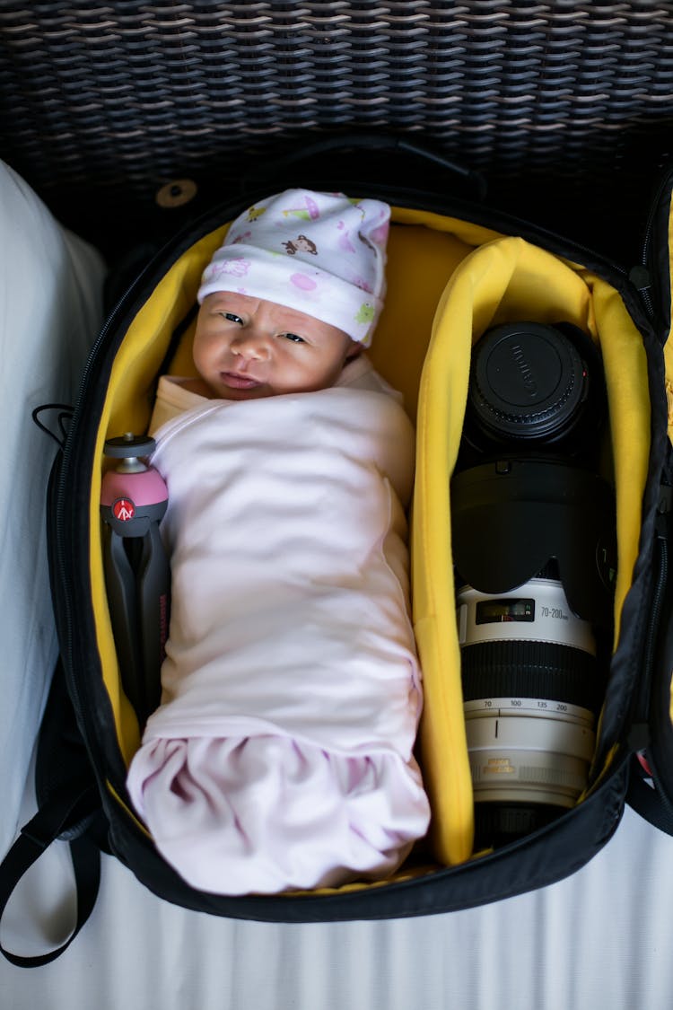 A Baby Inside A Camera Bag