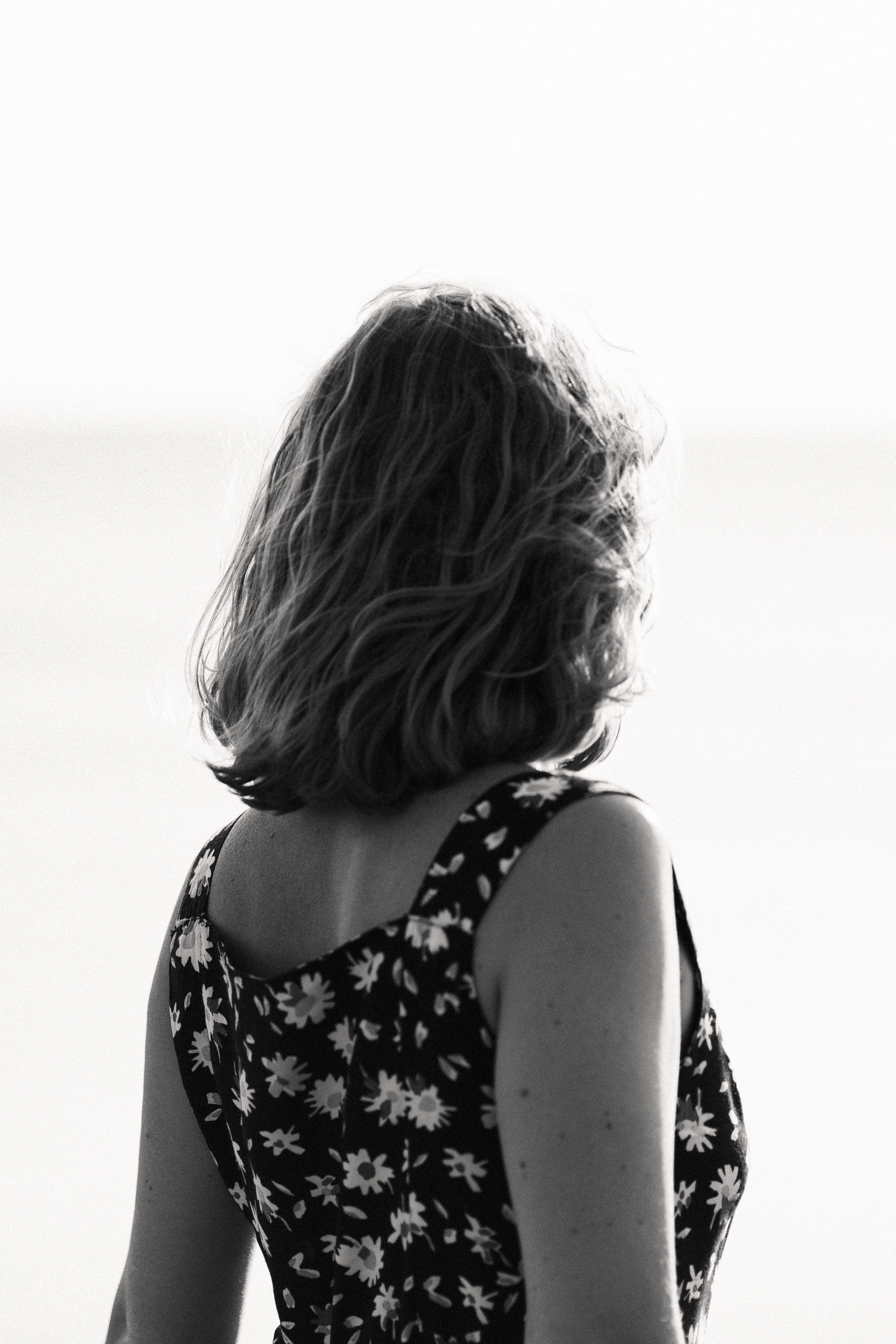 Grayscale Photo of a Woman in a Floral Dress · Free Stock Photo