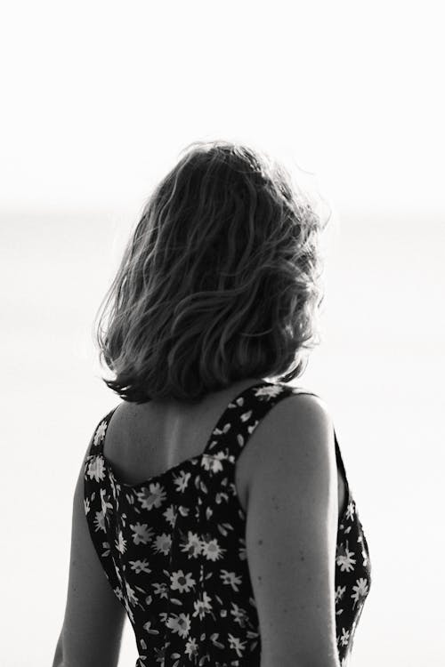 Grayscale Photo of a Woman in a Floral Dress