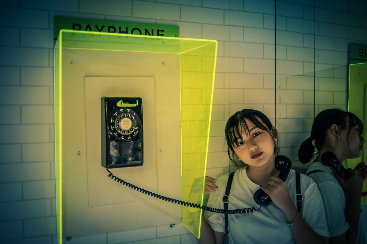 Woman speaking on a classic vintage telephone handset