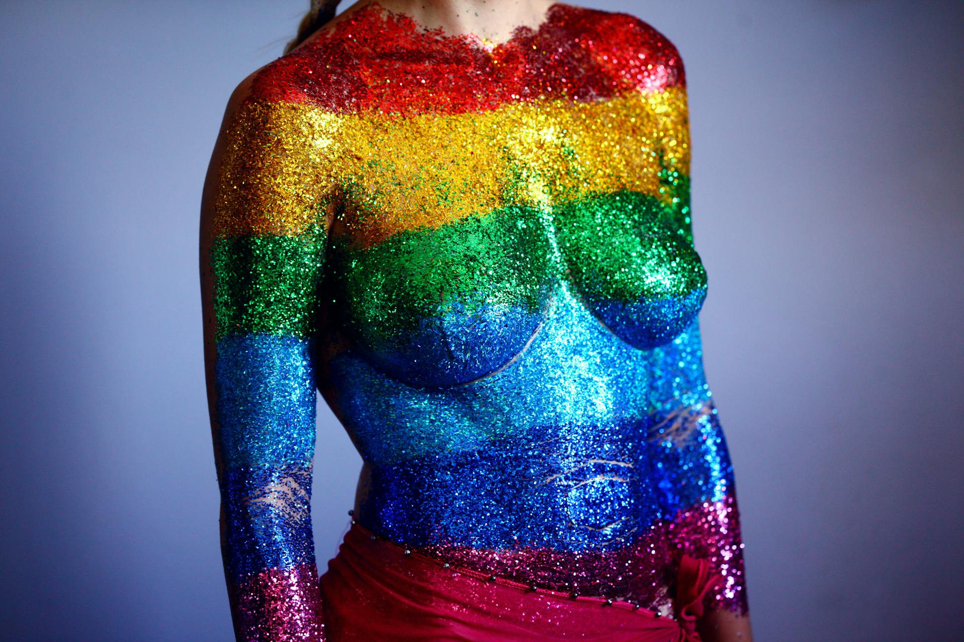 A colorful body art showcasing the LGBTQ pride with glitter stripes, celebrating diversity and expression.