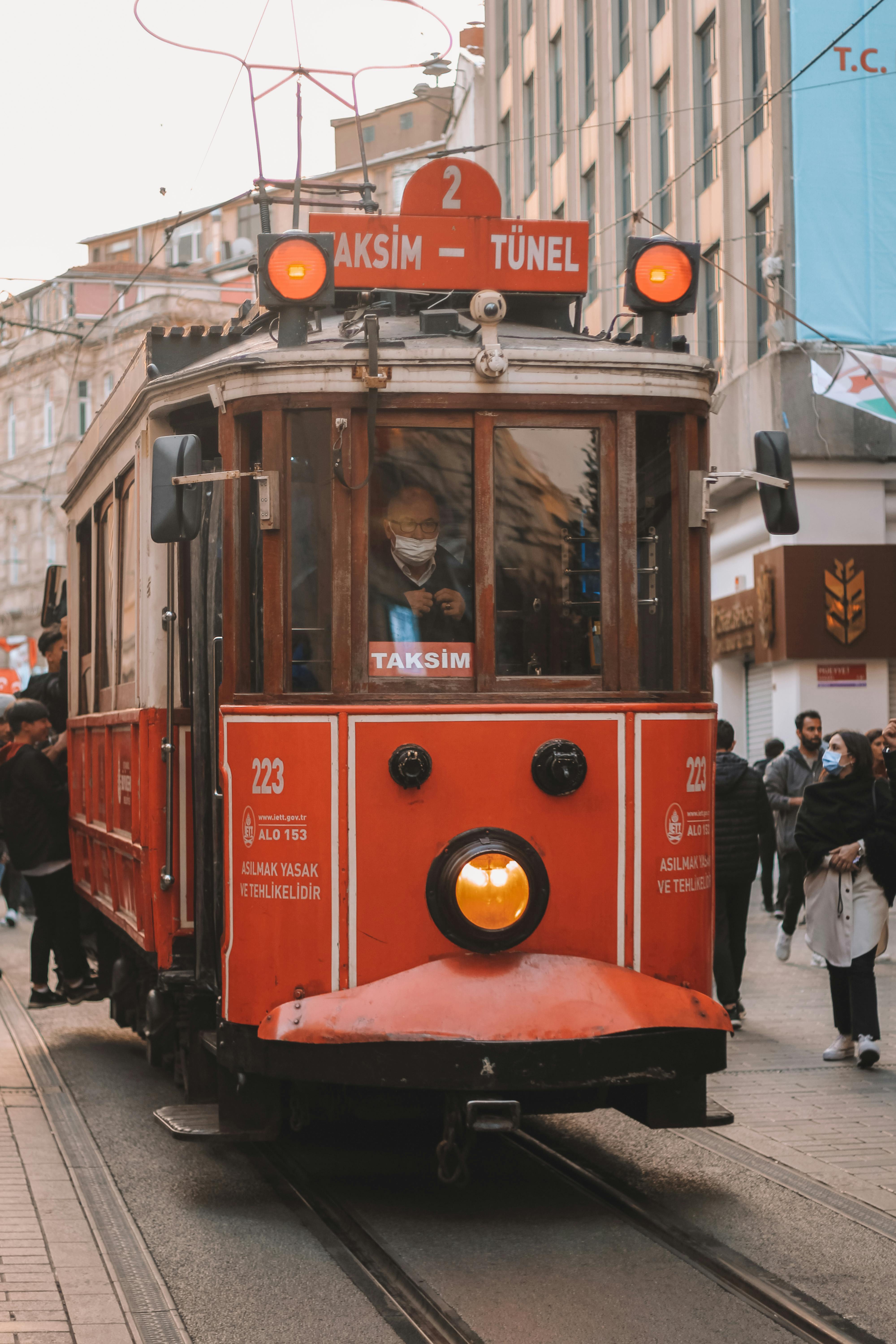 Free Historic red tram on bustling Istiklal Street in Istanbul, capturing local culture and daily life. Stock Photo