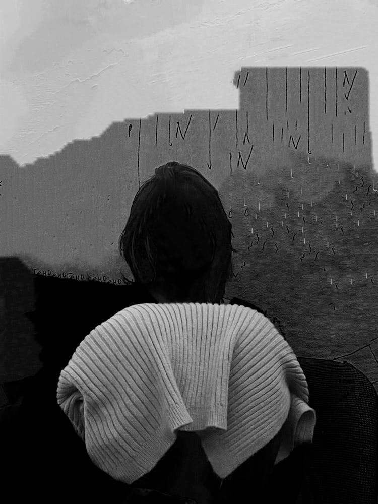 Grayscale Photo Of A Black Figure Holding A Folded Sweater