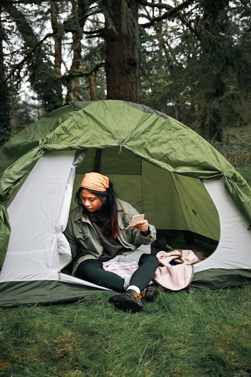 A Woman Sitting inside a Tent 