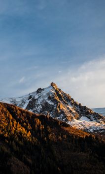 Breathtaking view of a snow-covered mountain peak at sunset in Zermatt, Switzerland.
