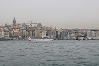 White Boat on Sea Near City Buildings