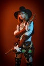Woman in Black Hat Holding Brown Wooden Stick