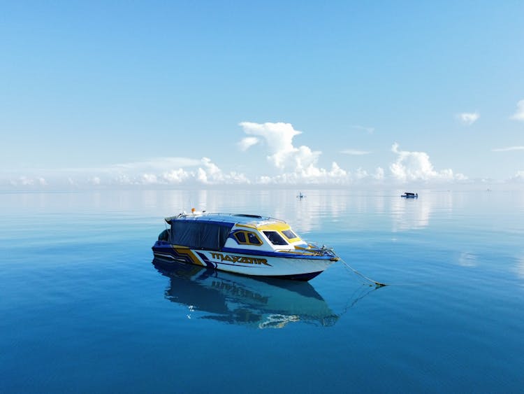 Reflection Of A Boat Anchored At Sea