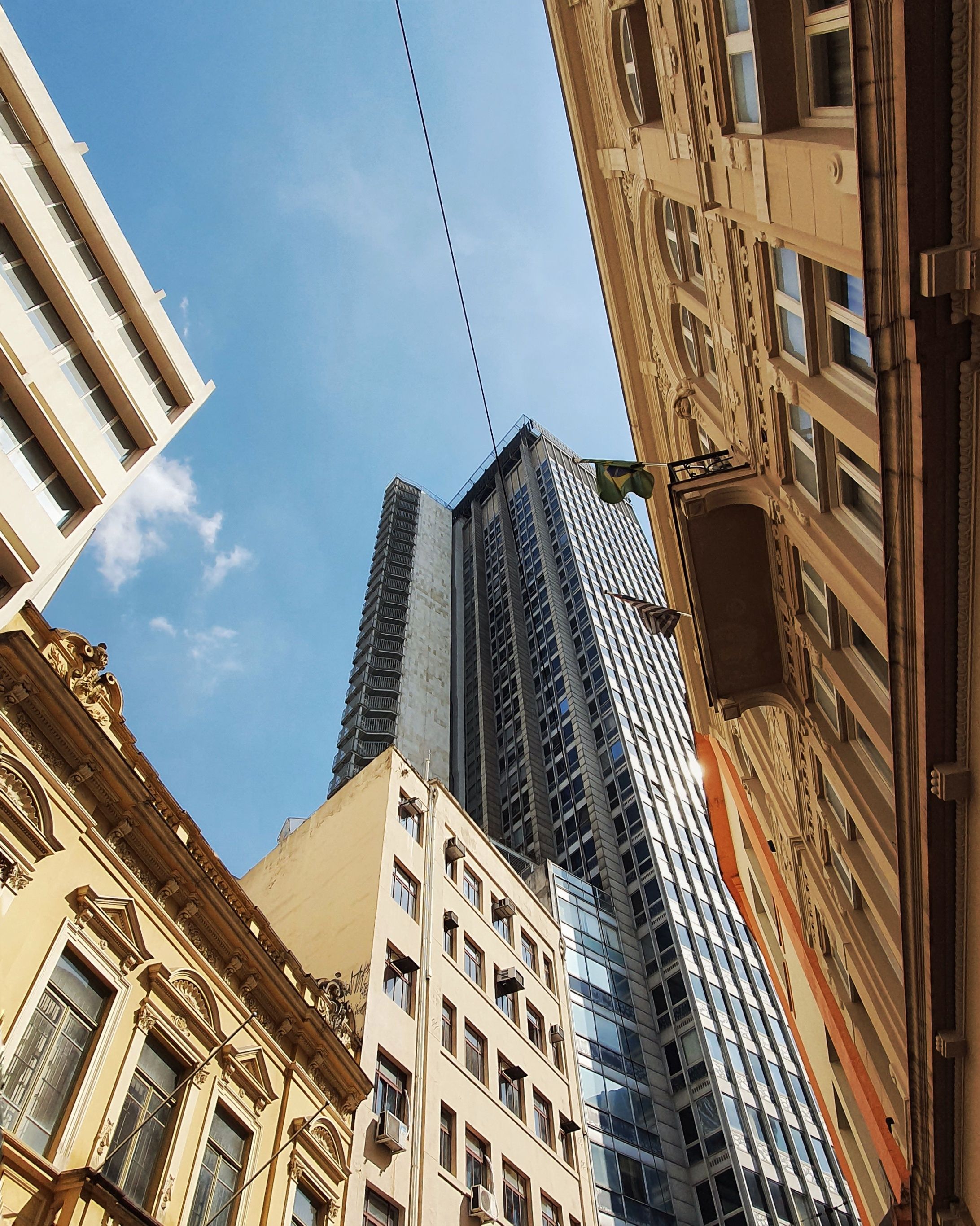 Low Angle Shot of High Rise Buildings Under the Blue Sky · Free Stock Photo